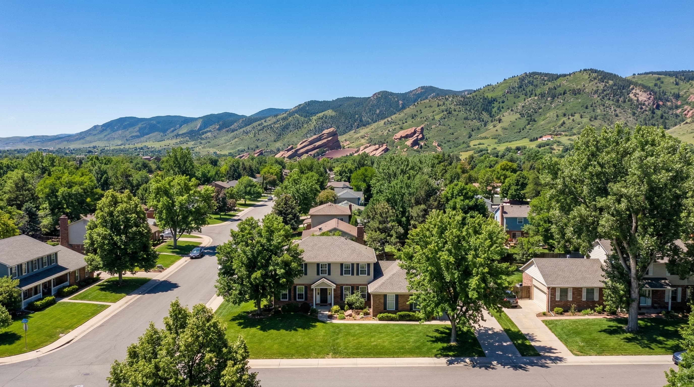 Lakewood Colorado with Green Mountain backdrop, suburban homes, and Denver skyline visible in the distance