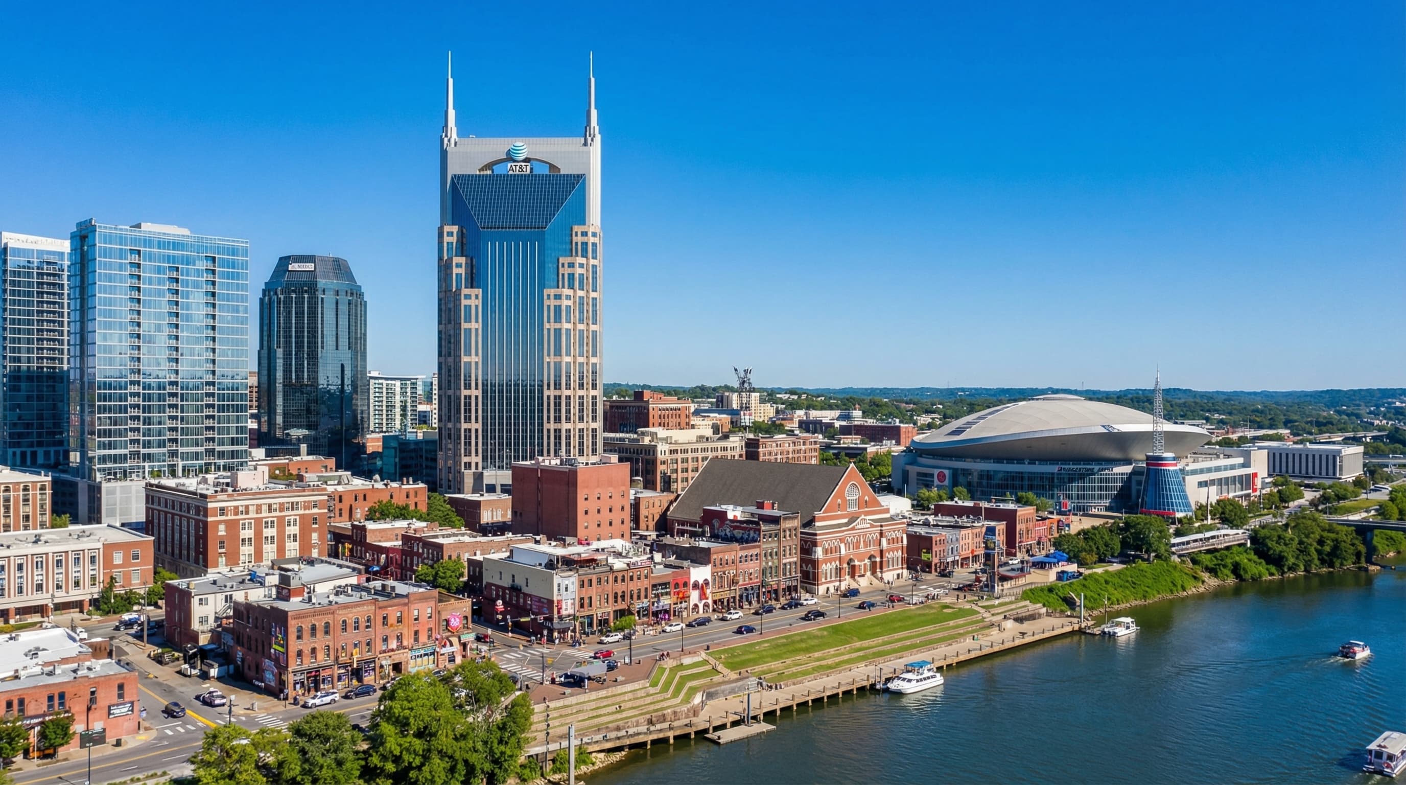 Nashville Tennessee skyline with Broadway honky-tonks, Cumberland River, and downtown towers at sunset