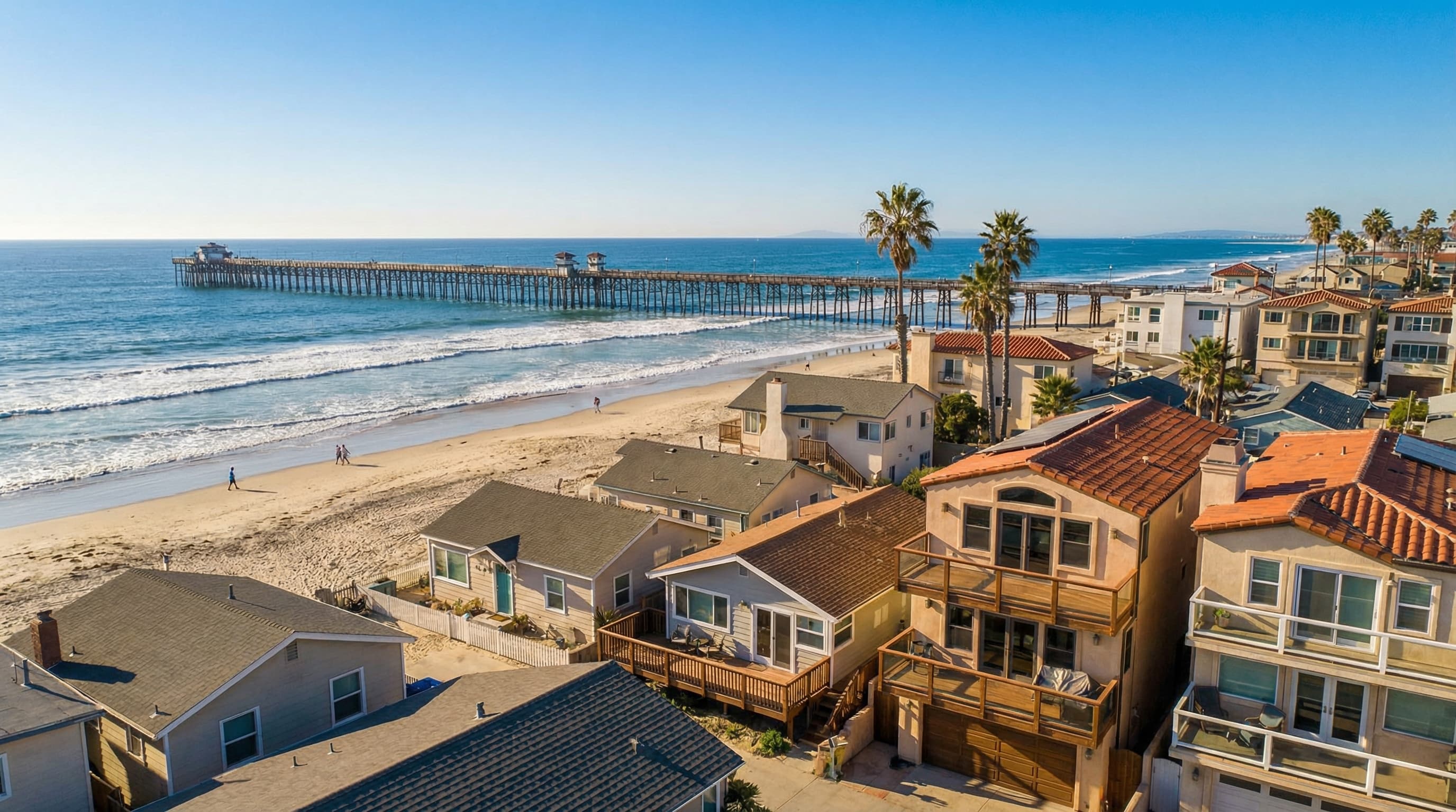 Beautiful Oceanside California beach community with iconic Oceanside Pier, beach homes and coastal architecture, Pacific Ocean waves on a bright sunny day